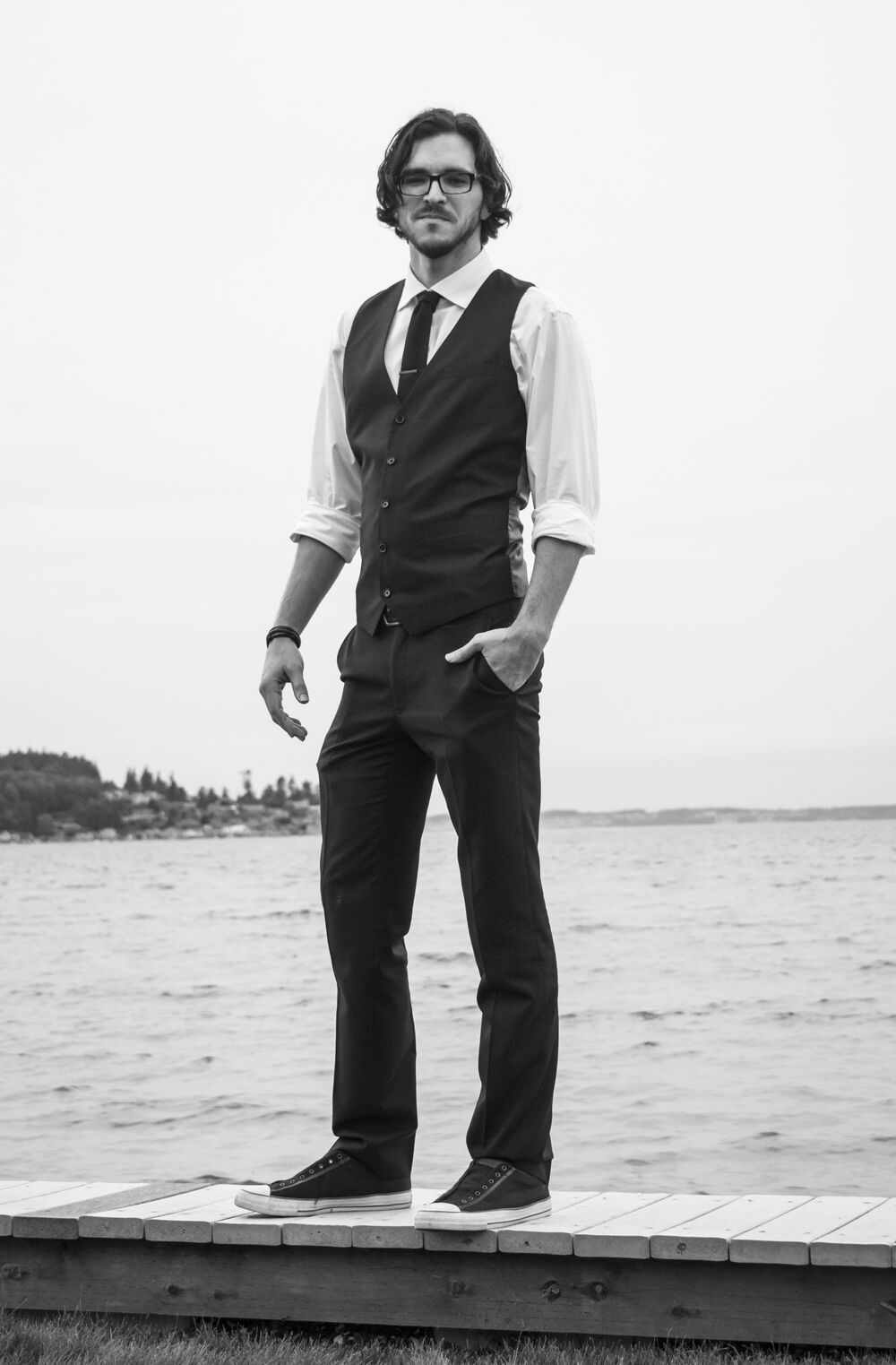 Jacob Black of Black Magic DJ, standing on a dock by the water